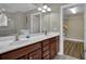 Bright bathroom featuring a double sink vanity, walk-in closet, and tile flooring at 8855 Radcliff Dr. Nw # 53C, Calabash, NC 28467