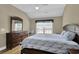 Comfortable bedroom with wood floors, ceiling fan, dresser, and window for ample natural light at 8855 Radcliff Dr. Nw # 53C, Calabash, NC 28467