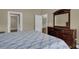 Bedroom with wood floors, dresser, and open doors, creating a welcoming and inviting space at 8855 Radcliff Dr. Nw # 53C, Calabash, NC 28467