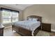 Cozy bedroom with vaulted ceiling, window, and wood floors provides a relaxing retreat at 8855 Radcliff Dr. Nw # 53C, Calabash, NC 28467