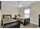 Cozy bedroom featuring two twin beds, wood-look flooring, and a ceiling fan at 8855 Radcliff Dr. Nw # 53C, Calabash, NC 28467