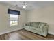 Comfortable bedroom featuring a stylish sofa and wood-look flooring at 8855 Radcliff Dr. Nw # 53C, Calabash, NC 28467