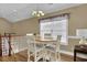 Charming dining area features a wood table and chairs near the staircase, perfect for Gathering meals at 8855 Radcliff Dr. Nw # 53C, Calabash, NC 28467