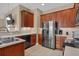Well-equipped kitchen with stainless steel refrigerator, dark wood cabinets, and ample counter space at 8855 Radcliff Dr. Nw # 53C, Calabash, NC 28467