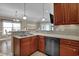 Spacious kitchen featuring stainless steel appliances, wooden cabinets, and an open view to the living room at 8855 Radcliff Dr. Nw # 53C, Calabash, NC 28467