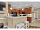 The kitchen boasts a breakfast bar with seating, dark wood cabinets, and stainless steel appliances at 8855 Radcliff Dr. Nw # 53C, Calabash, NC 28467