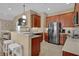 Modern kitchen featuring stainless steel appliances, warm wood cabinetry, and a breakfast bar with seating at 8855 Radcliff Dr. Nw # 53C, Calabash, NC 28467