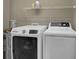 Well-equipped laundry room with modern washer and dryer, plus overhead storage at 8855 Radcliff Dr. Nw # 53C, Calabash, NC 28467