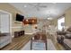 Open-concept living room with wood floors and view of the dining area and kitchen, creating a welcoming and airy space at 8855 Radcliff Dr. Nw # 53C, Calabash, NC 28467