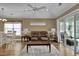 Spacious living room with dining area, seating, wood floors, and slider doors to the screened in patio at 8855 Radcliff Dr. Nw # 53C, Calabash, NC 28467