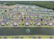 An aerial view reveals charming townhomes nestled along a scenic waterway with lush greenery at 8855 Radcliff Dr. Nw # 53D, Calabash, NC 28467