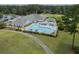 Overhead view of a clubhouse with a large pool, surrounding foliage, and green landscape at 8855 Radcliff Dr. Nw # 53D, Calabash, NC 28467