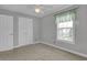 Bedroom features a ceiling fan, window, and closet at 8855 Radcliff Dr. Nw # 53D, Calabash, NC 28467