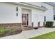 Inviting entryway with a decorative door, brick steps, and convenient storage units at 8855 Radcliff Dr. Nw # 53D, Calabash, NC 28467