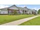 Clubhouse exterior with lawn and sidewalk leading to the main entrance at 8855 Radcliff Dr. Nw # 53D, Calabash, NC 28467