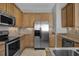 Well-equipped kitchen with stainless steel appliances, tile backsplash, and ample cabinet space at 8855 Radcliff Dr. Nw # 53D, Calabash, NC 28467