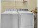 Laundry area with washer, dryer, and overhead shelving at 8855 Radcliff Dr. Nw # 53D, Calabash, NC 28467
