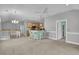 Bright living room with open floor plan that leads to kitchen island with seating at 8855 Radcliff Dr. Nw # 53D, Calabash, NC 28467