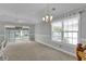 Bright living room with plush carpeting, sliding glass doors, and natural light at 8855 Radcliff Dr. Nw # 53D, Calabash, NC 28467