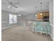 Open-concept living space featuring a staircase, large windows, and kitchen island with seating at 8855 Radcliff Dr. Nw # 53D, Calabash, NC 28467