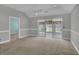 Spacious living room featuring a ceiling fan and glass sliding doors to a water view at 8855 Radcliff Dr. Nw # 53D, Calabash, NC 28467