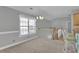 Cozy living space with large windows, comfortable seating, and an open staircase at 8855 Radcliff Dr. Nw # 53D, Calabash, NC 28467