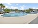 Community pool with chairs, landscaping, and palm trees surrounding the pool at 8855 Radcliff Dr. Nw # 53D, Calabash, NC 28467