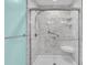 Bathroom featuring a stylish walk-in shower with marble-patterned walls and accessible grab bars at 8855 Radcliff Dr. Nw # 53D, Calabash, NC 28467