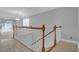 Bright stairway featuring tile flooring, white railings, and natural light from a nearby window at 8855 Radcliff Dr. Nw # 53D, Calabash, NC 28467