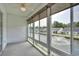 Bright sunroom with large windows showcasing views of the water and well-manicured lawns at 8855 Radcliff Dr. Nw # 53D, Calabash, NC 28467