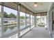 Relaxing sunroom with tranquil water views and roll-down shades for comfort and privacy at 8855 Radcliff Dr. Nw # 53D, Calabash, NC 28467