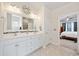 Bright bathroom with a dual sink vanity, a large mirror, modern fixtures, and access to the bedroom at 924 Sorano St., Myrtle Beach, SC 29579