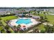 Aerial view of a community pool area featuring lounge chairs, playground, and shaded seating areas at 924 Sorano St., Myrtle Beach, SC 29579
