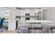 Modern kitchen featuring white cabinets, mosaic backsplash, stainless steel appliances, and a spacious island at 924 Sorano St., Myrtle Beach, SC 29579