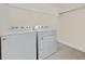 Functional laundry room featuring a washer, a dryer, and shelving for storage at 924 Sorano St., Myrtle Beach, SC 29579