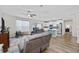 Open living space with ceiling fan, modern flooring, and view of a kitchen with white cabinets and stainless steel appliances at 924 Sorano St., Myrtle Beach, SC 29579