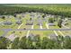 Desirable community with a picturesque pond and well-maintained lawns, surrounded by lush greenery and mature trees at 95 Timber Run Dr., Georgetown, SC 29440