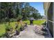 Outdoor patio area with barbeque, seating, and lush, green, fenced backyard at 95 Timber Run Dr., Georgetown, SC 29440