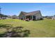 Spacious backyard with a patio, screened porch, and well-manicured lawn at 95 Timber Run Dr., Georgetown, SC 29440