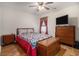 Cozy bedroom features a ceiling fan, natural light, and matching wooden furniture at 95 Timber Run Dr., Georgetown, SC 29440