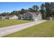 The home features a long driveway and an attached garage, complemented by a well-maintained lawn at 95 Timber Run Dr., Georgetown, SC 29440