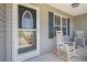 The front porch features rocking chairs and a decorative glass front door at 95 Timber Run Dr., Georgetown, SC 29440