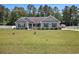 Charming single-story home featuring a well-manicured lawn and quaint landscaping at 95 Timber Run Dr., Georgetown, SC 29440