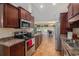 Open kitchen featuring stainless steel appliances, dark wood cabinets, and a view to the dining area at 95 Timber Run Dr., Georgetown, SC 29440