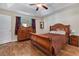 Main bedroom features a tray ceiling, ceiling fan and beautiful wooden furniture at 95 Timber Run Dr., Georgetown, SC 29440