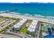 Beautiful aerial view of oceanfront condos with a pool, beach access, and nearby pier at 9660 Shore Dr. # 208, Myrtle Beach, SC 29572