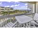 Balcony view features a white outdoor table set and overlooks the beach and buildings at 9660 Shore Dr. # 208, Myrtle Beach, SC 29572