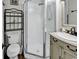 Functional bathroom with a corner shower, toilet, and vanity with storage at 9660 Shore Dr. # 208, Myrtle Beach, SC 29572
