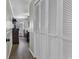 Hallway leading to a bedroom, featuring ample closet space and hardwood floors at 9660 Shore Dr. # 208, Myrtle Beach, SC 29572