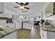 Open-concept kitchen with white cabinets, appliances, and a view into the living room at 9660 Shore Dr. # 208, Myrtle Beach, SC 29572